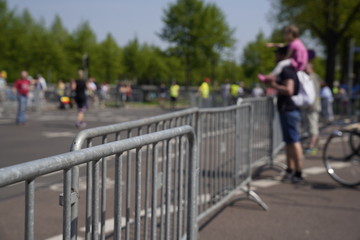 Fototapeta na wymiar Marathon barrier with blurred people in the background
