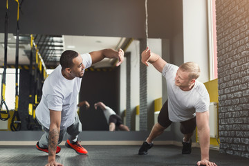 Two happy men fitness workout together at gym - Powered by Adobe