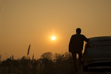 one man and the car with a trip before sunset.