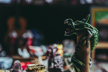 side view of figurine of Chinese green dragon, blurred background