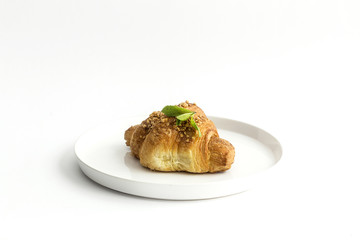 Croissant with almonds on white background
