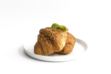 Croissant with almonds on white background