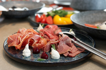 Assortment of cured and smoked meats and roast beef