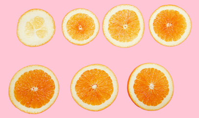 slices of fresh orange on a pink background on layers isolated