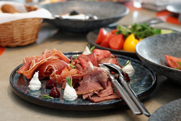 Assortment of cured and smoked meats and roast beef