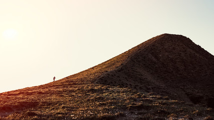 A traveler climbs a mountain