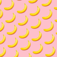 Fototapeta na wymiar Colorful fruit pattern of yellow bananas on pink background top view