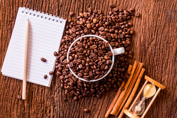 white coffee cup and roasted coffee beans around