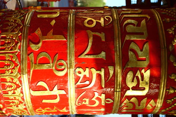 Photo of the Red prayer drums in a Buddhist temple at day time.