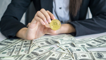Rich men carry bitcoins new currency and banknotes US dollar bill on the table business concept