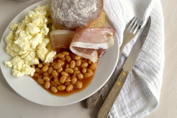 traditional English breakfast. Eggs, bacon, beans and bread.