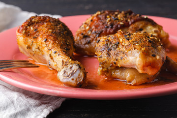 Marinated grilled healthy chicken breasts cooked on a summer BBQ and served with fresh herbs