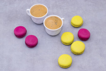 Macaroni cakes on a gray concrete background.