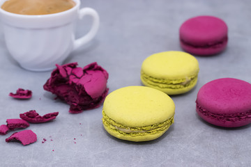 Macaroni cakes on a gray concrete background.