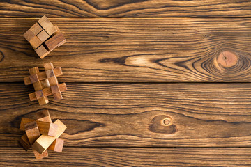 Three complex wooden puzzles or brainteasers