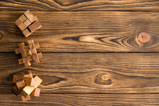 Three complex wooden puzzles or brainteasers