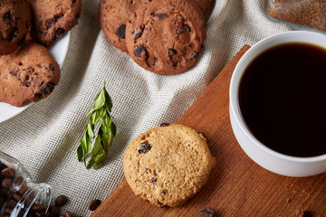 Breakfast background with mug of fresh coffee, homemade oatmeal cookies, grind coffee