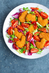 Chicken nuggets with salad. Fresh vegetable salad of tomatoes, lettuce and chicken nuggets