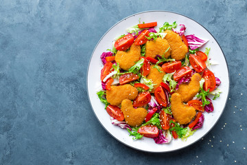 Chicken nuggets with salad. Fresh vegetable salad of tomatoes, lettuce and chicken nuggets