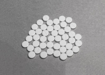 pile of tablets on cardboard paper.