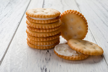 sandwich biscuits with white cream filling on white wood background