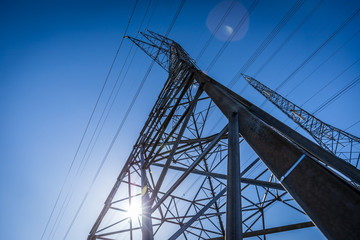 High voltage electrical pylons ruling the sky.