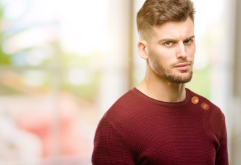 Fototapeta premium Handsome young man irritated and angry expressing negative emotion, annoyed with someone