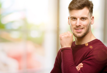 Naklejka premium Handsome young man confident and happy with a big natural smile laughing