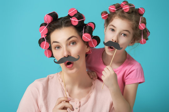 Mother and her daughter with a paper accessories