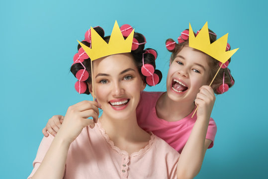 Mother and her daughter with a paper accessories