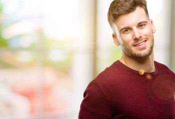 Naklejka premium Handsome young man confident and happy with a big natural smile laughing, natural expression