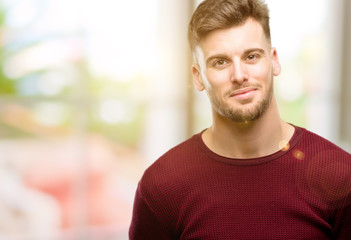 Obraz premium Handsome young man confident and happy with a big natural smile laughing