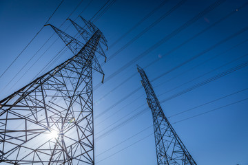 High voltage electrical pylons ruling the sky.
