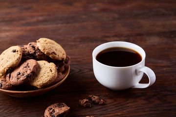 Breakfast background with mug of fresh coffee, homemade oatmeal cookies, grind coffee