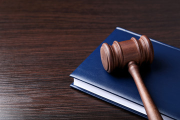 Judge gavel with book on wooden table