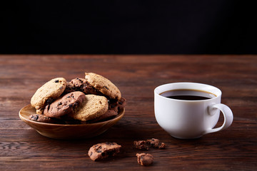 Breakfast background with mug of fresh coffee, homemade oatmeal cookies, grind coffee