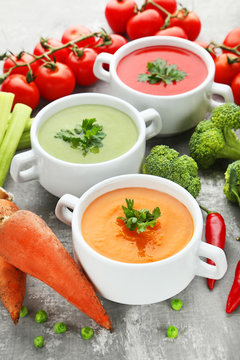 Vegetable cream soup with parsley on grey wooden table