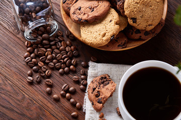 Breakfast background with mug of fresh coffee, homemade oatmeal cookies, grind coffee
