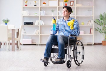 Disabled man on wheelchair cleaning home