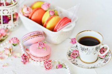 Dessert: A Delicate Fresh Colorful French Macaroons In Pastel Colors With Flowers Roses On A Light Textile Background, Top View
