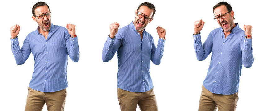 Middle age handsome man happy and excited expressing winning gesture. Successful and celebrating victory, triumphant over white background