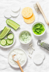 Calming cucumber yogurt mask. Ingredients for homemade cucumber face mask-cucumber, natural yogurt, probiotic capsule, sponges, brush on white background, top view. Flat lay