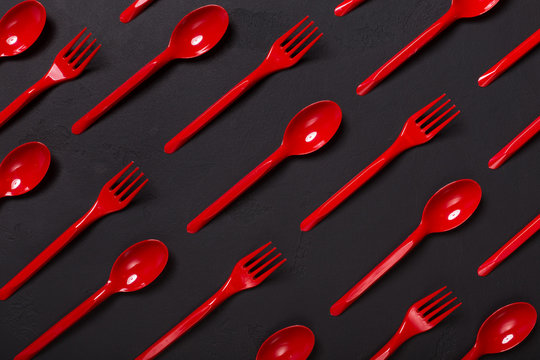 Top view on plastic forks on black background