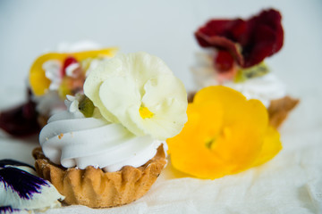 cake with fresh fruit and edible flowers Pansy Flowers on light background
