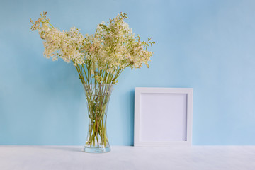 Mockup with a white frame and summer flowers