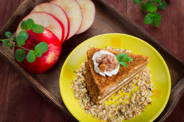 Honey cake on a plate. Wooden rustic background