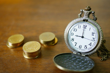 vintage golden pocket watch with stack  on wood table background.