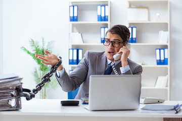 Busy employee chained to his office desk