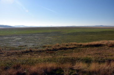 Empty Lake George nestled between a rural wind farm and farmland in Australia. Lake George is an endorheic lake, as it has no outflow of water to rivers and oceans.