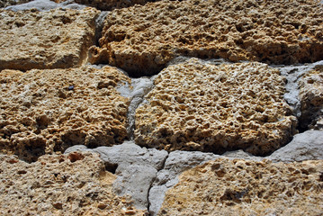 Crimean coquina rock blocks with cement wall close up texture background